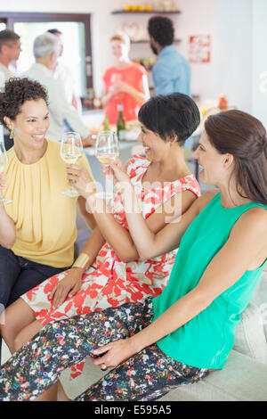 Women toasting each other at party Stock Photo