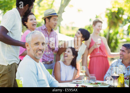 Man smiling at party outdoors Stock Photo