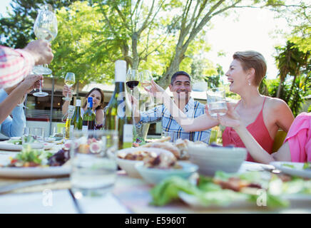 Friends toasting each other at party Stock Photo