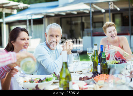 Friends eating together outdoors Stock Photo