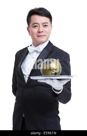 Waiter holding globe on tray Stock Photo