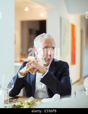 Man sitting at dinner party Stock Photo
