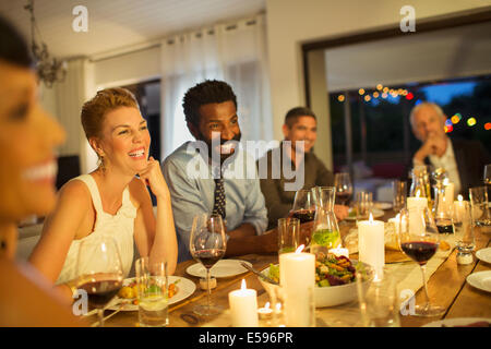 Friends laughing at dinner party Stock Photo