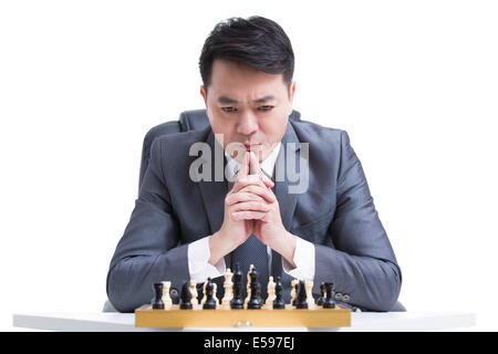 Businessman playing chess Stock Photo