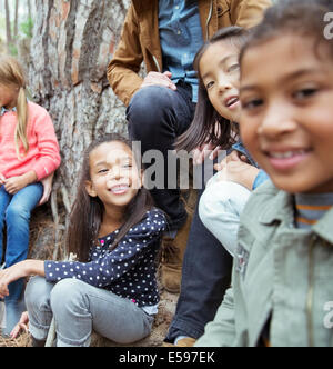 Students and teacher sitting outdoors Stock Photo