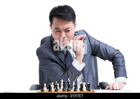 Businessman playing chess Stock Photo