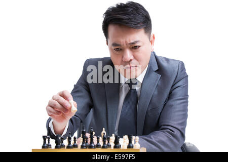 Businessman playing chess Stock Photo