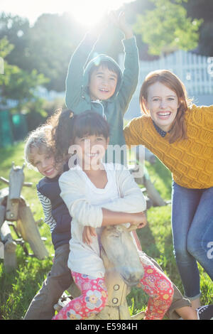 Students and teacher smiling outdoors Stock Photo