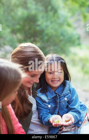 Teacher and student examining plants outdoors Stock Photo