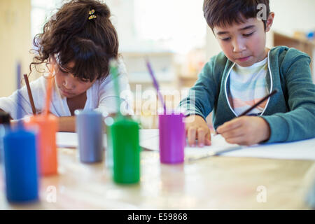 Students painting in classroom Stock Photo