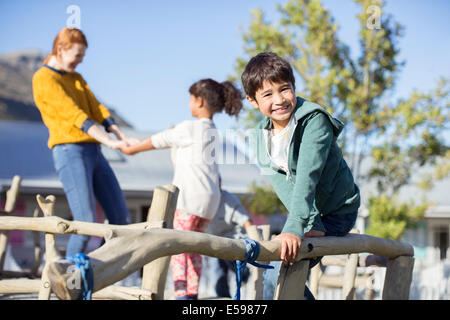 Teacher and students playing outdoors Stock Photo