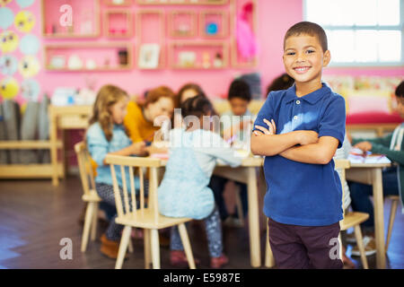 Student smiling in classroom Stock Photo