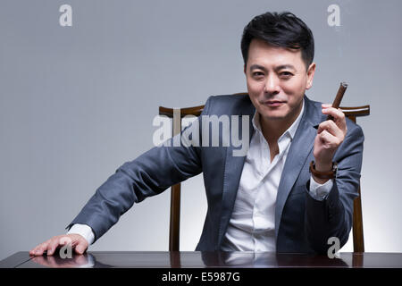 Mature businessman with cigar Stock Photo