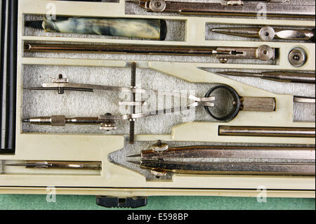 Old drawing tools in a box on a green background Stock Photo