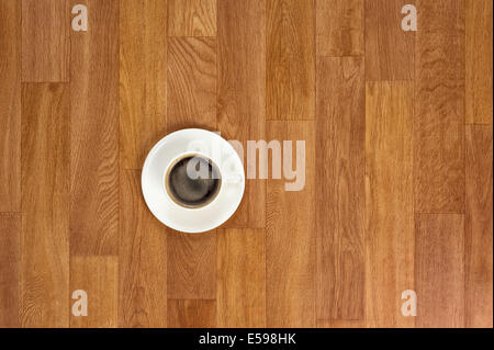 White cup of coffee on wooden table. Above view. Stock Photo