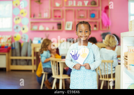 Student holding painting in classroom Stock Photo