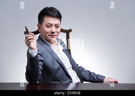 Mature businessman with cigar Stock Photo