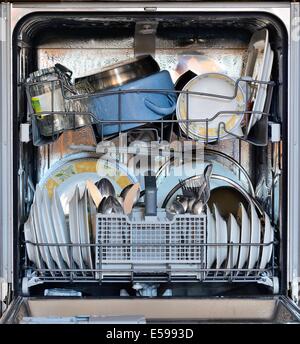 Open the front door of the dishwasher full of clean dishes Stock Photo