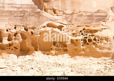 Pock marks in rock formation caused by erosion due to repeated exposure to wind and water Stock Photo