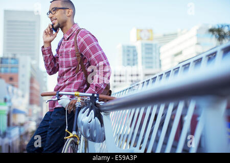 Man talking on cell phone on city street Stock Photo