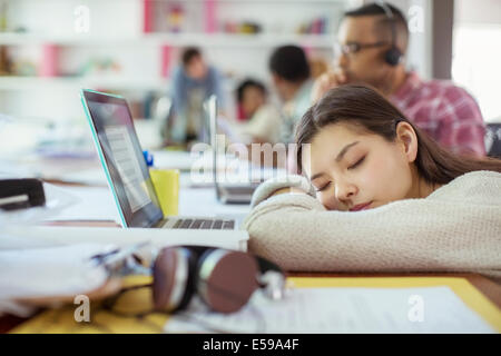 Woman sleeping at conference table Stock Photo