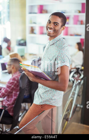 Man carrying folders in office Stock Photo