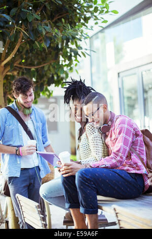 Friends talking at sidewalk cafe Stock Photo