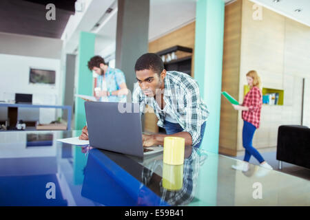 Man working on laptop in office Stock Photo