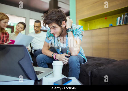 People working at laptop in office Stock Photo