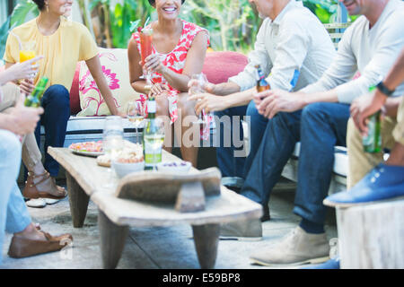 Friends relaxing together at party Stock Photo