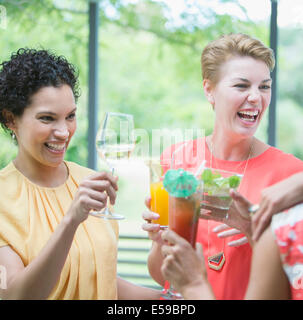Women toasting each other at party Stock Photo