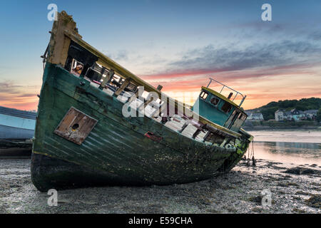 An old wrecked wooden boat on the shore