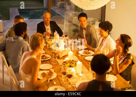 Friends eating together at dinner party Stock Photo