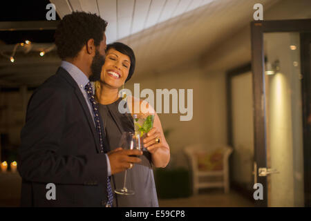 Couple kissing at party Stock Photo