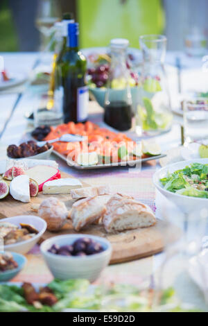 Plates of food on table outdoors Stock Photo