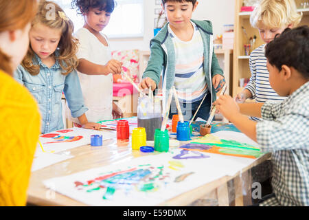 Students painting in classroom Stock Photo