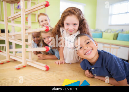 Students and teacher smiling in classroom Stock Photo