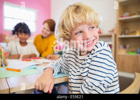 Student smiling in classroom Stock Photo