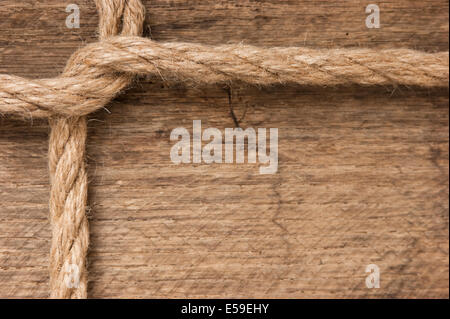 frame made of rope on a wooden background Stock Photo