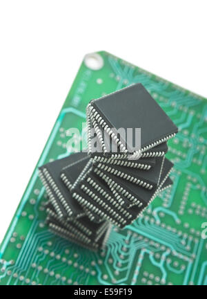 pile of microchips on a printed circuit board isolated on white background Stock Photo