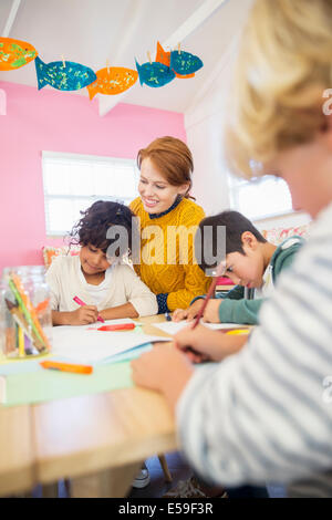 Students and teacher drawing in classroom
