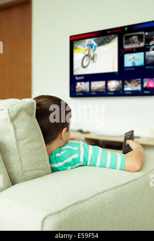 Boy watching television in living room Stock Photo