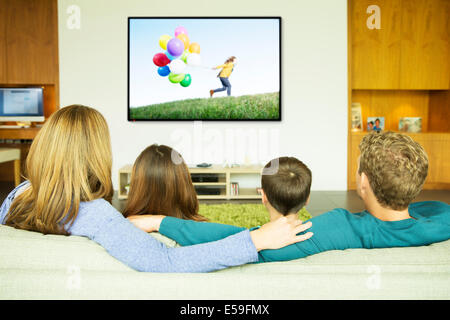 Family watching television in living room Stock Photo