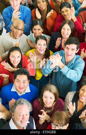 Portrait of happy crowd clapping Stock Photo