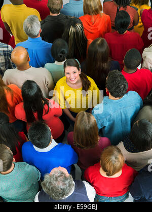 Smiling woman in crowd Stock Photo