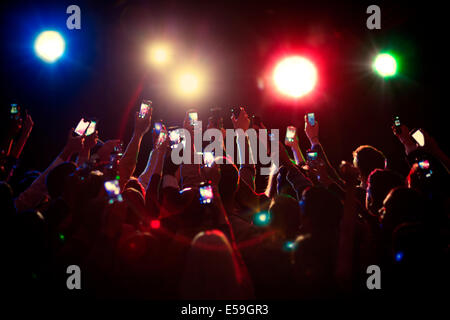 Audience using camera phones at concert Stock Photo