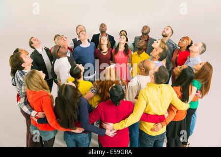 Business people forming circle and looking up Stock Photo