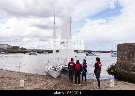 Sailing school students launching a sailboat for a lesson from Bray, County Wicklow, Ireland. Stock Photo