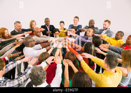 Business people connecting hands in huddle Stock Photo