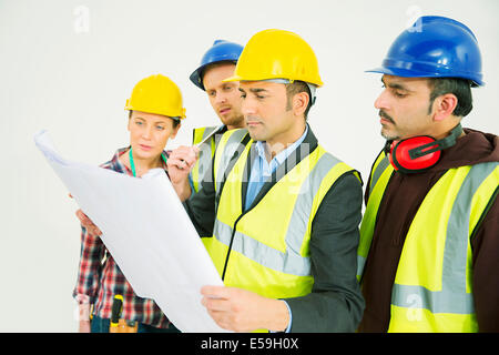 Construction workers viewing blueprints Stock Photo